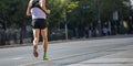 Running in the city roads. Young man runner, back view, blur background Royalty Free Stock Photo