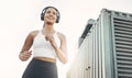 Running, city or woman with headphones, fitness or workout goal for wellness, health or relax. Female person, runner or