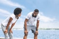 Afro Couple Catching Breath After Morning Jog Along River Royalty Free Stock Photo