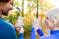 Running couple with smart phones and earphones