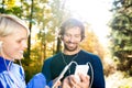 Running couple with smart phones and earphones Royalty Free Stock Photo