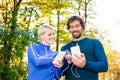 Running couple with smart phones and earphones