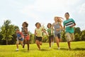 Running into a day of fun. a group of diverse and happy kids playing together outside. Royalty Free Stock Photo