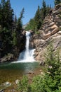 Running Eagle Falls waterfall on a sunny day, in the Two Medicine area of Glacier National Park USA Royalty Free Stock Photo