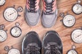 Running equipment. Stopwatch and running shoes. Time for run. Sport running accessories on the wooden floor. Sports rivalry.