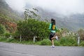 Running, exercise and woman on road on mountain for training, workout and fitness outdoors. Sports, nature and person on Royalty Free Stock Photo