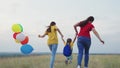 running family park. happy mother child kid run teamwork. colorful air balloons fly wind. mom girl daughter travel Royalty Free Stock Photo