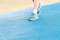 running feet male in runner jogging exercise with old shoes for health lose weight concept on track rubber cover blue public park Royalty Free Stock Photo