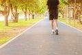 Running feet male in runner jogging exercise with old shoes for health lose weight concept on track rubber cover blue public park Royalty Free Stock Photo