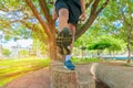 Running feet male view from below in runner jogging exercise with old shoes in public park for health lose weight concept