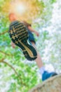 Running feet male view from below in runner jogging exercise with old shoes in public park for health lose weight concept Royalty Free Stock Photo