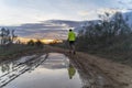 Running in the field at sunset in shorts, with sneakers.