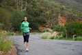 Running, fitness and woman on road on mountain for training, workout and exercise outdoors. Sports, nature and person on Royalty Free Stock Photo