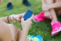 Running girls having fun in the park with mobile phone. Royalty Free Stock Photo
