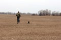 Running Guy With A Black Dog On A Plowed Black Field