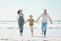 Running, happy and holding hands with family on the beach for support, summer vacation or bonding. Freedom, health and Royalty Free Stock Photo