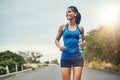 Running has become revitalizing. a young beautiful woman training for a marathon outdoors. Royalty Free Stock Photo