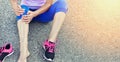 Running injury leg accident- sport woman runner hurting holding painful sprained ankle in pain. Royalty Free Stock Photo