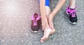 Running injury leg accident- sport woman runner hurting holding painful sprained ankle in pain. Royalty Free Stock Photo