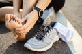 Running injury leg accident- sport woman runner hurting holding painful sprained ankle in pain. Female athlete with joint or Royalty Free Stock Photo