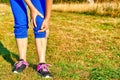 Running injury leg accident- sport woman runner hurting holding painful sprained ankle in pain. Royalty Free Stock Photo