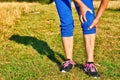 Running injury leg accident- sport woman runner hurting holding painful sprained ankle in pain. Royalty Free Stock Photo