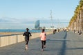 Running jogging on Barcelona Beach, Barceloneta. Healthy lifestyle people runners training outside on boardwalk. Multiracial coup Royalty Free Stock Photo