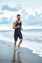 Running Man Jogging At Beach During Fitness Workout Outdoor. Sport Royalty Free Stock Photo