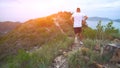 Running man on mountain road. Sport fitness boy exercising outside in mountains. Living healthy lifestyle enjoying Royalty Free Stock Photo