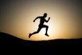 Running man silhouette at sunset sky Royalty Free Stock Photo