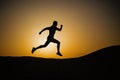 Running man silhouette at sunset sky Royalty Free Stock Photo