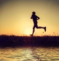 Running man silhouette in sunset time Royalty Free Stock Photo