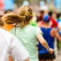 Woman running the marathon at start or finish line.