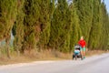 Running mother with stroller enjoying motherhood at sunset lands