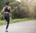 Running in nature, woman from back and fitness, mockup space and trees on healthy workout on path. Exercise, health and