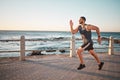 Running, ocean and mockup with a man runner training outdoor on the promenade for cardio or endurance. Fitness, sea and Royalty Free Stock Photo