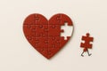 The running piece of the heart-shaped puzzle is a metaphor for loss. Space for text. Royalty Free Stock Photo