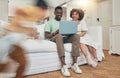 Running, playing and family with a laptop in the living room for movie, streaming and show online. Interracial, happy Royalty Free Stock Photo