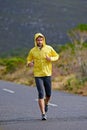 Running, rain and man with challenge, fitness and endurance with workout and cardio. Road, runner and athlete with Royalty Free Stock Photo