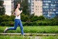 Running in rainy weather in summer by woman 29 years old in leggins. Royalty Free Stock Photo