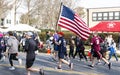 Running road 5K race carrying American Flag