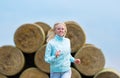 The running romantic girl outdoors against hay stack Royalty Free Stock Photo