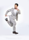 Running, rush and business man late for work jumping, hurry and sprint for appointment in studio. Corporate mockup, time Royalty Free Stock Photo