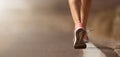 Running shoe closeup of woman running on road