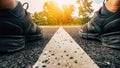 Running shoes, athlete running sport feet on asphalt road with straight white line and sunset background