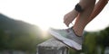 Running shoes. close up female athlete tying laces for jogging on road. Runner ties getting ready for training. Sport Royalty Free Stock Photo