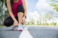 Running shoes - closeup of woman tying shoe laces. Female sport fitness runner getting ready for jogging in garden background Royalty Free Stock Photo