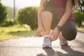 Running shoes - closeup of woman tying shoe laces. Female sport fitness runner getting ready for jogging in garden background Royalty Free Stock Photo