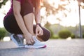 Running shoes - closeup of woman tying shoe laces. Female sport fitness runner getting ready for jogging in garden background Royalty Free Stock Photo