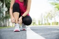 Running shoes - closeup of woman tying shoe laces. Female sport fitness runner getting ready for jogging in garden background Royalty Free Stock Photo